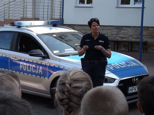 Policjantka omawia zasady ruchu drogowego.