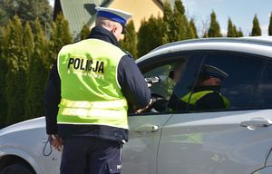 Policjant bada stan trzeźwości kierującego pojazdem