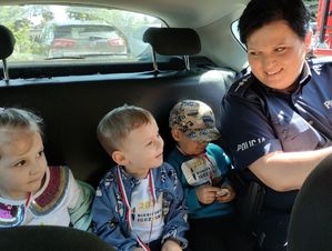 Policjantka z dziećmi w radiwozie