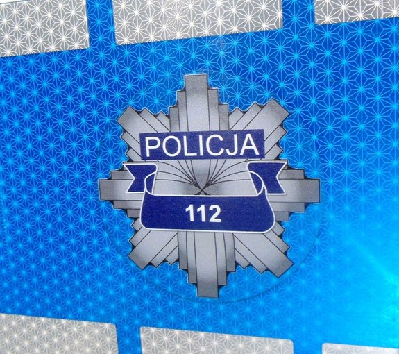 Na zdjęciu policyjna gwiazda z zapisanym na jej środku numerem alarmowym 112