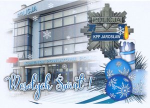 Kartka świąteczna na której widnieje budynek KPP Jarosław, gwiazda policyjna, stroik świąteczny oraz napis Wesołych Świąt