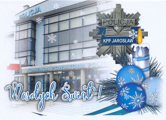 Kartka świąteczna na której widnieje budynek KPP Jarosław, gwiazda policyjna, stroik świąteczny oraz napis Wesołych Świąt