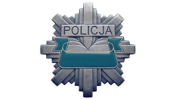 Odznaka policyjna - srebrna gwiazda z niebieską szarfą i i napisem POLICJA.
