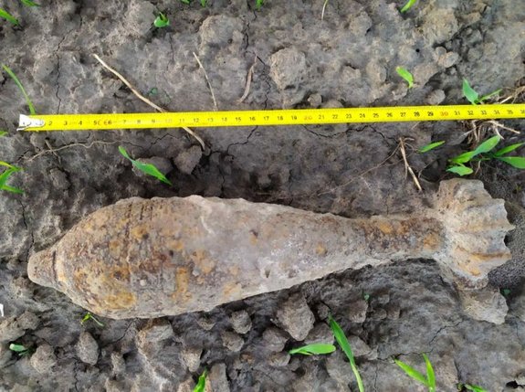 Skorodowany granat moździerzowy znaleziony na polu ornym.