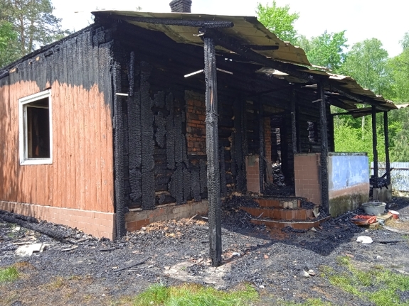 Częściowo spalony drewniany dom.