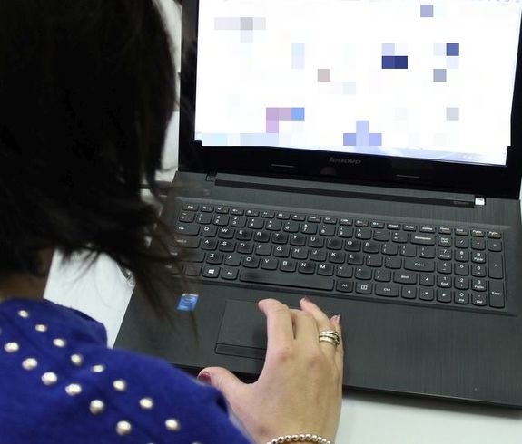 Kobieta siedząca przed ekranem komputera