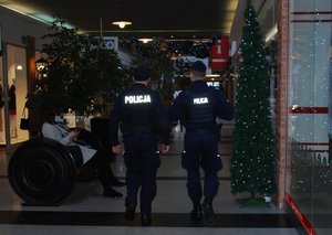 Dwóch policjantów w trakcie kontroli galerii handlowej,