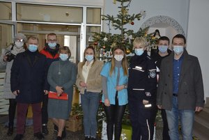 Zdjęcie kolorowe wykonane w porze dziennej , przedstawia hol hospicjum &quot;Santa Rita &quot; w Przemyślu .Na zdjęciu widoczne są osoby które przyniosły prezenty dla pensjonariuszy.