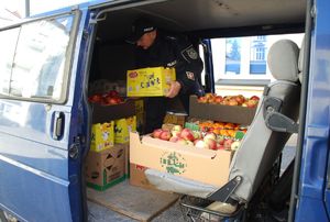Na zdjęciach na dziedzińcu rzeszowskiej komendy umundurowania policjanci pakują do furgonetki zakupione ze składek artykuły pierwszej potrzeby dla uchodźców z Ukrainy.