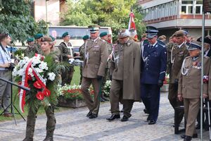 uroczystości przed pomnikiem, wiązankę składają przedstawiciele służb mundurowych