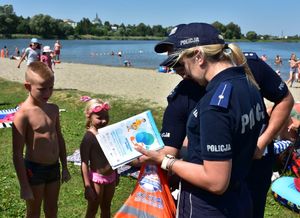 Policjanci rozmawiają z dziećmi na plaży o ich bezpieczeństwie
