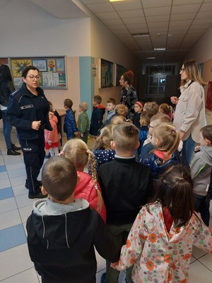 policjantka prowadzi pogadankę z dziećmi .