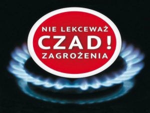 Palnik gazowy, wewnątrz kółko koloru czerwonego z biała obwolutą i napis Nie lekceważ czad! zagrożenia, tło koloru czarnego