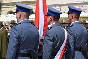 policjanci stojący na rynku ze sztandarem