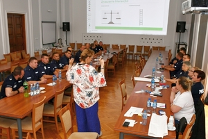 Policjanci i uczestnicy szkolenia z komunikacji międzykulturowej w auli komendy wojewódzkiej