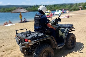 Policjant na quadzie jedzie po plaży