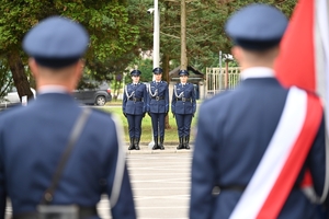 Policjanci podczas uroczystości pod tablicami poświęconymi pamięci poległych policjantów