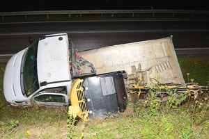 dostawcze iveco przewożące koparkę w przydrożnym rowie