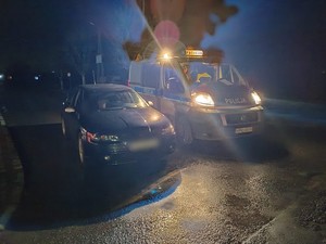 policyjny radiowóz stojący obok zatrzymanego do kontroli seata