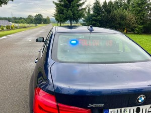 Radiowóz policyjny grupy "Speed" z włączoną sygnalizacją świetlną na tle drogi.