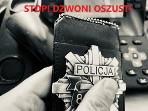Zdjęcie przedstawia na samej górze napis w kolorze czerwonym &quot;STOP! DZWONI OSZUST!&quot;, poniżej na zdjęciu trzymana w dłoni odznaka policyjna, a w jej tle widać apart telefoniczny z odłożoną słuchawką.