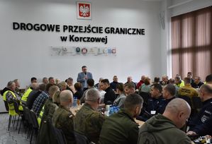 Sala konferencyjna na której znajdują się przedstawiciele służb mundurowych i osoby cywilne