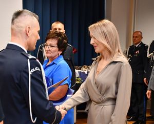 Komendant wręcza list gratulacyjny kobiecie