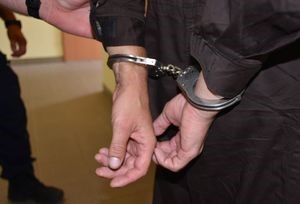 Mężczyzna ma na rękach założone kajdanki