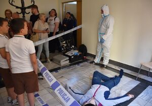 Technik kryminalistyki i osoby uczestniczące  w symulacyjnych oględzinach miejsca zdarzenia