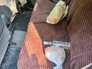 Leżąca butelka wódki na siedzeniu kontrolowanego pojazdu