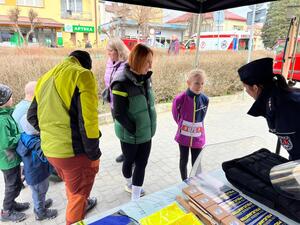 policjanci na policyjnym stoisku podczas biegu ulicznego promują pracę w Policji