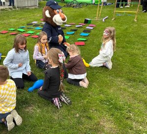 policyjna maskotka lew podczas zabawy z dziećmi w plenerze na pikniku rodzinnym