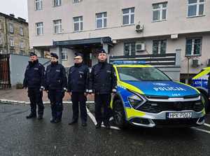 umundurowani policjanci na parkingu przed komendą policji w Przemyślu i zaparkowane radiowozy, podczas przekazania  nowych radiowozów.