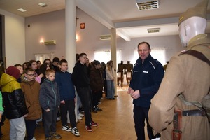 Policjant podczas pokazu mundurów wojskowych i profilaktyki z młodzież